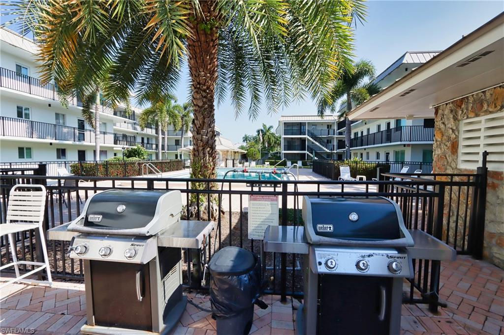 766 Central Avenue, Unit 119 Naples, FL 34102 - Photo 15 of 15 a terrace with outdoor seating and city view