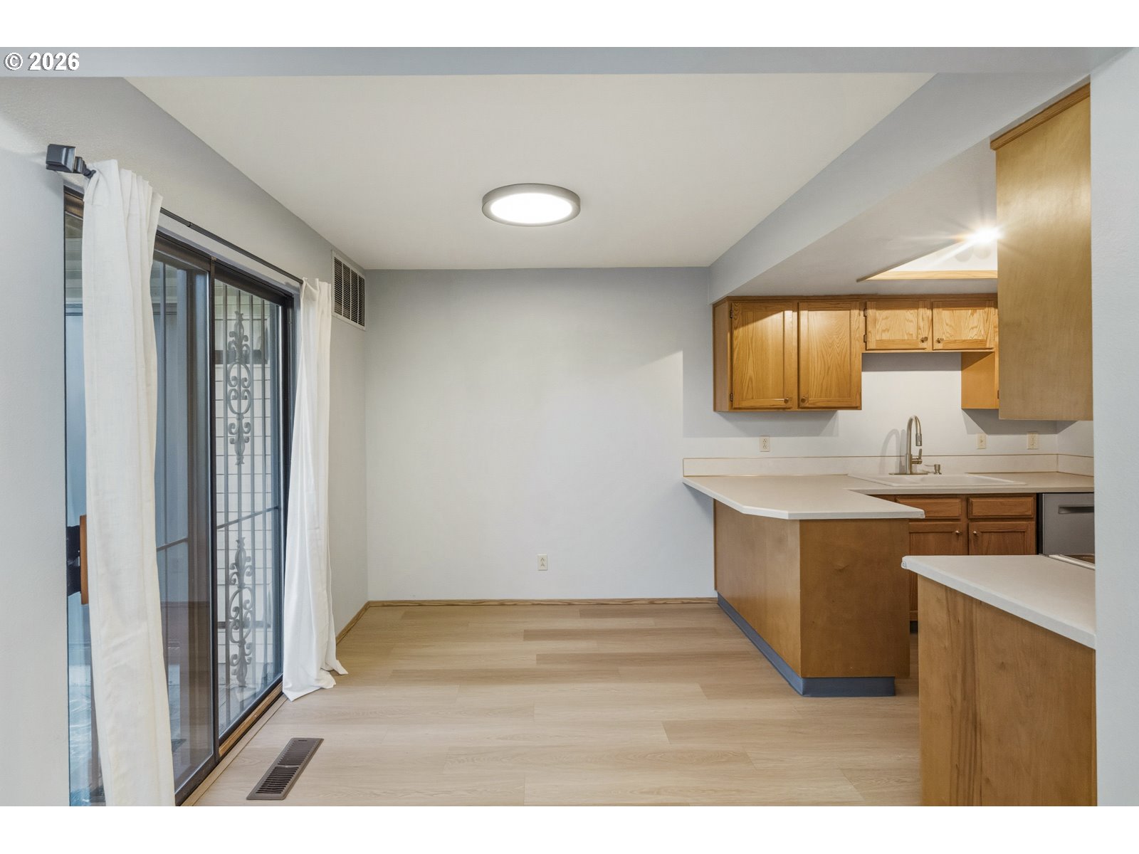 12516 Southeast Stark Street, Unit C Portland, OR 97233 - Photo 11 of 47 a view of kitchen with wooden floor