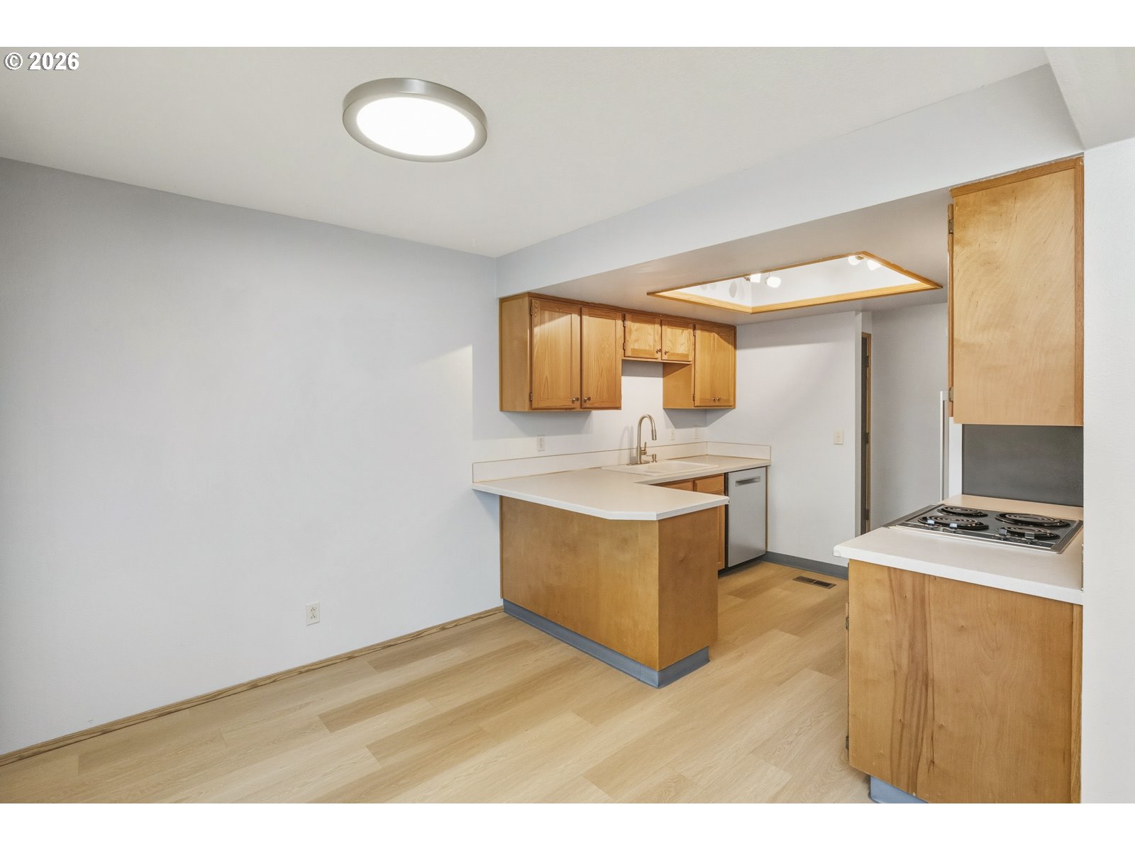 12516 Southeast Stark Street, Unit C Portland, OR 97233 - Photo 12 of 47 a kitchen with a sink cabinets and wooden floor
