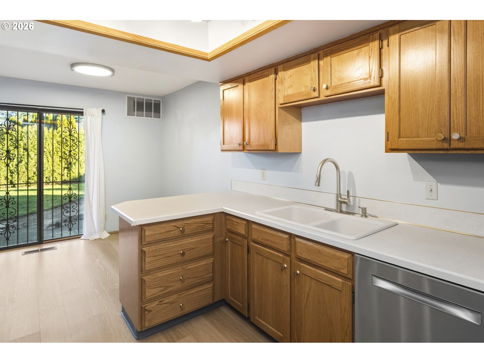 12516 Southeast Stark Street, Unit C Portland, OR 97233 - Photo 13 of 47 a kitchen with a wooden cabinets and a sink