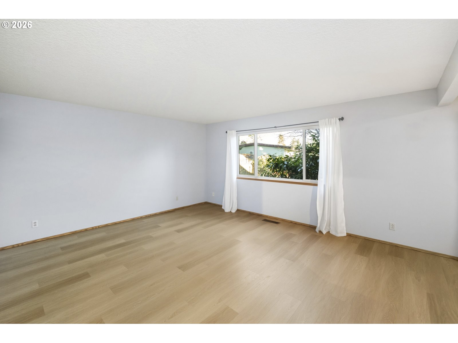 12516 Southeast Stark Street, Unit C Portland, OR 97233 - Photo 14 of 47 a view of an empty room with a window