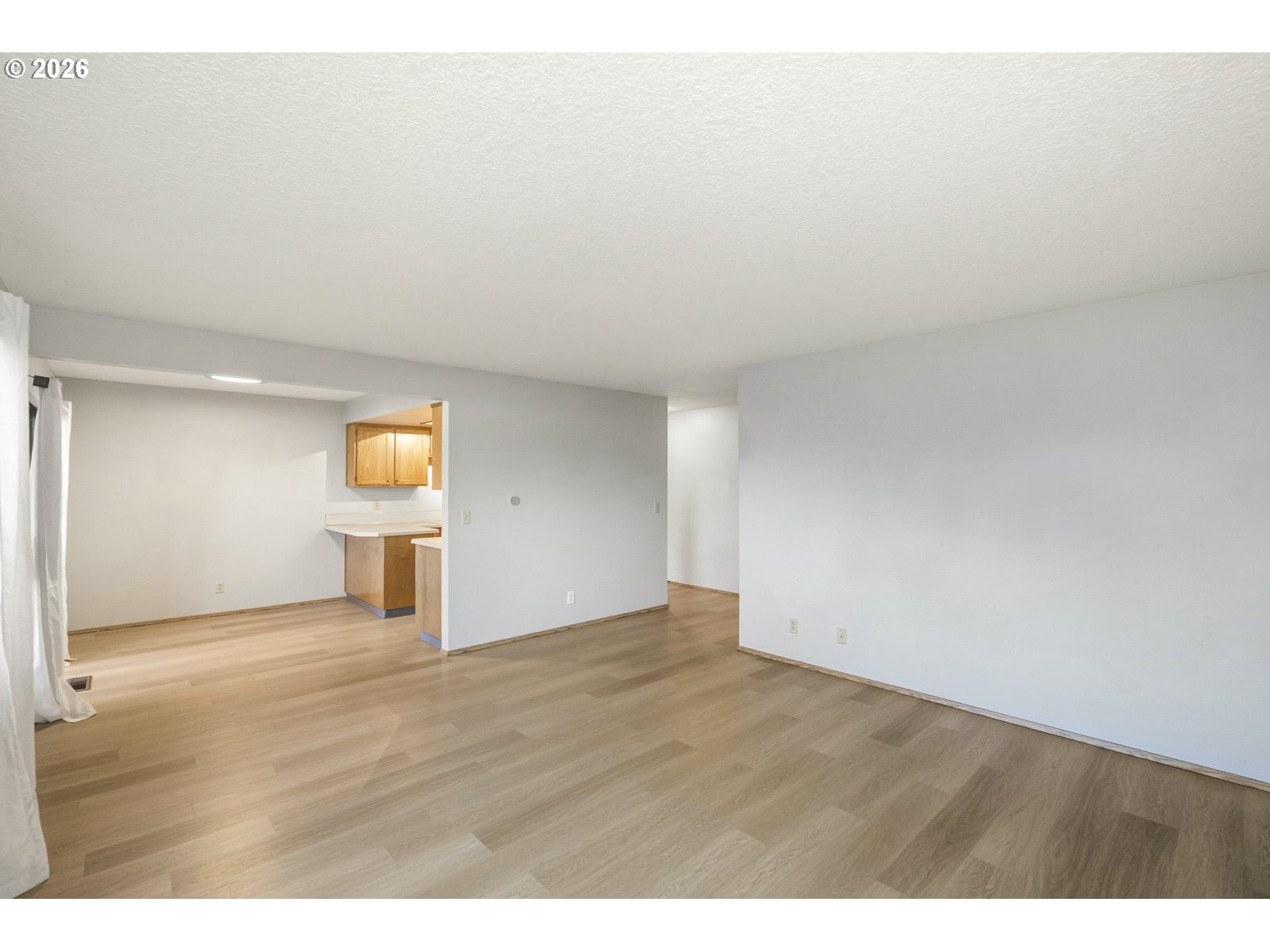 12516 Southeast Stark Street, Unit C Portland, OR 97233 - Photo 19 of 47 a view of empty room with a window