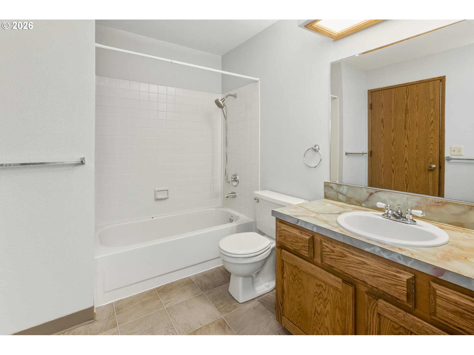 12516 Southeast Stark Street, Unit C Portland, OR 97233 - Photo 23 of 47 a bathroom with a sink a toilet and a bathtub