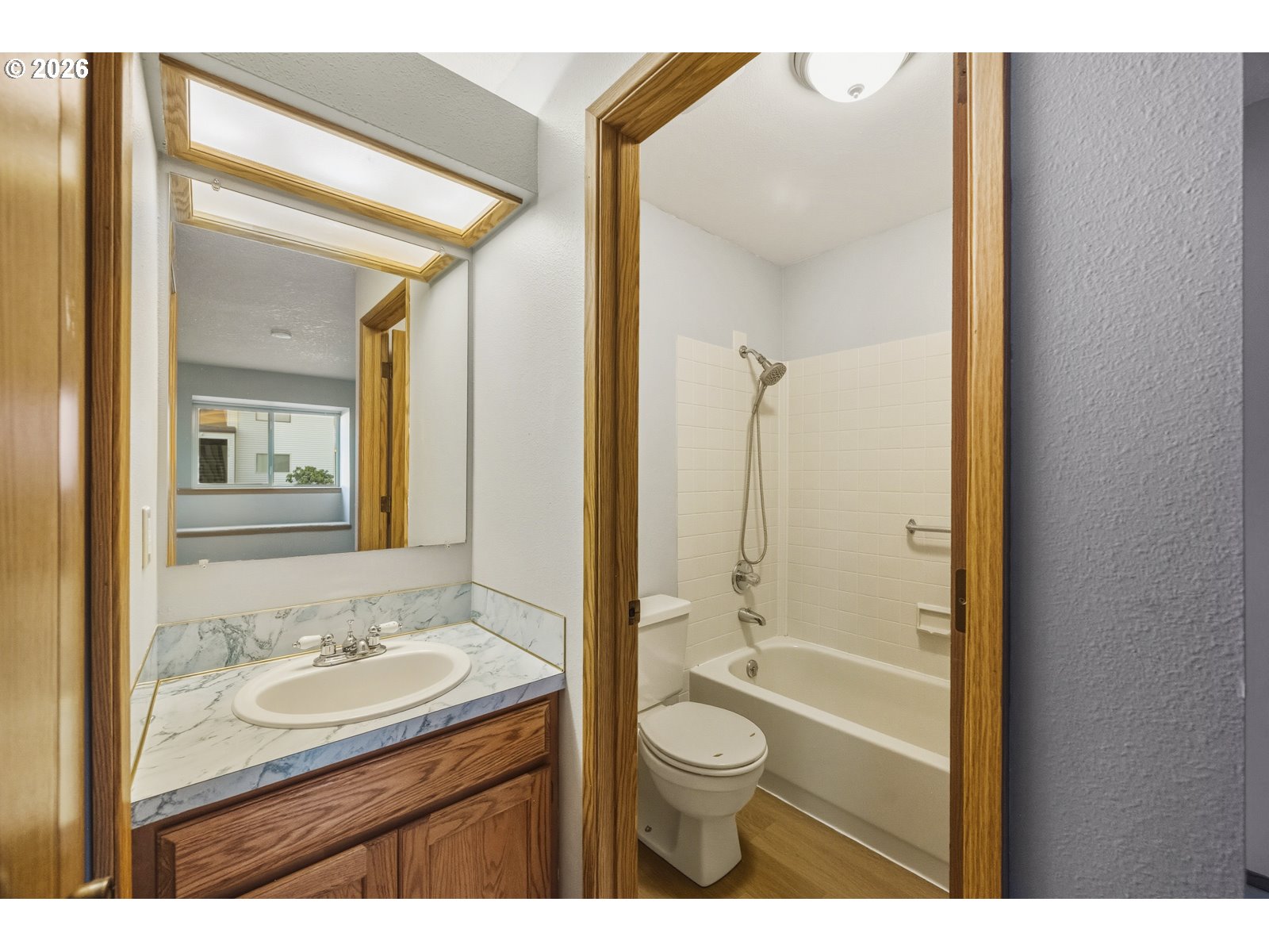 12516 Southeast Stark Street, Unit C Portland, OR 97233 - Photo 34 of 47 a bathroom with a granite countertop sink toilet a mirror and shower