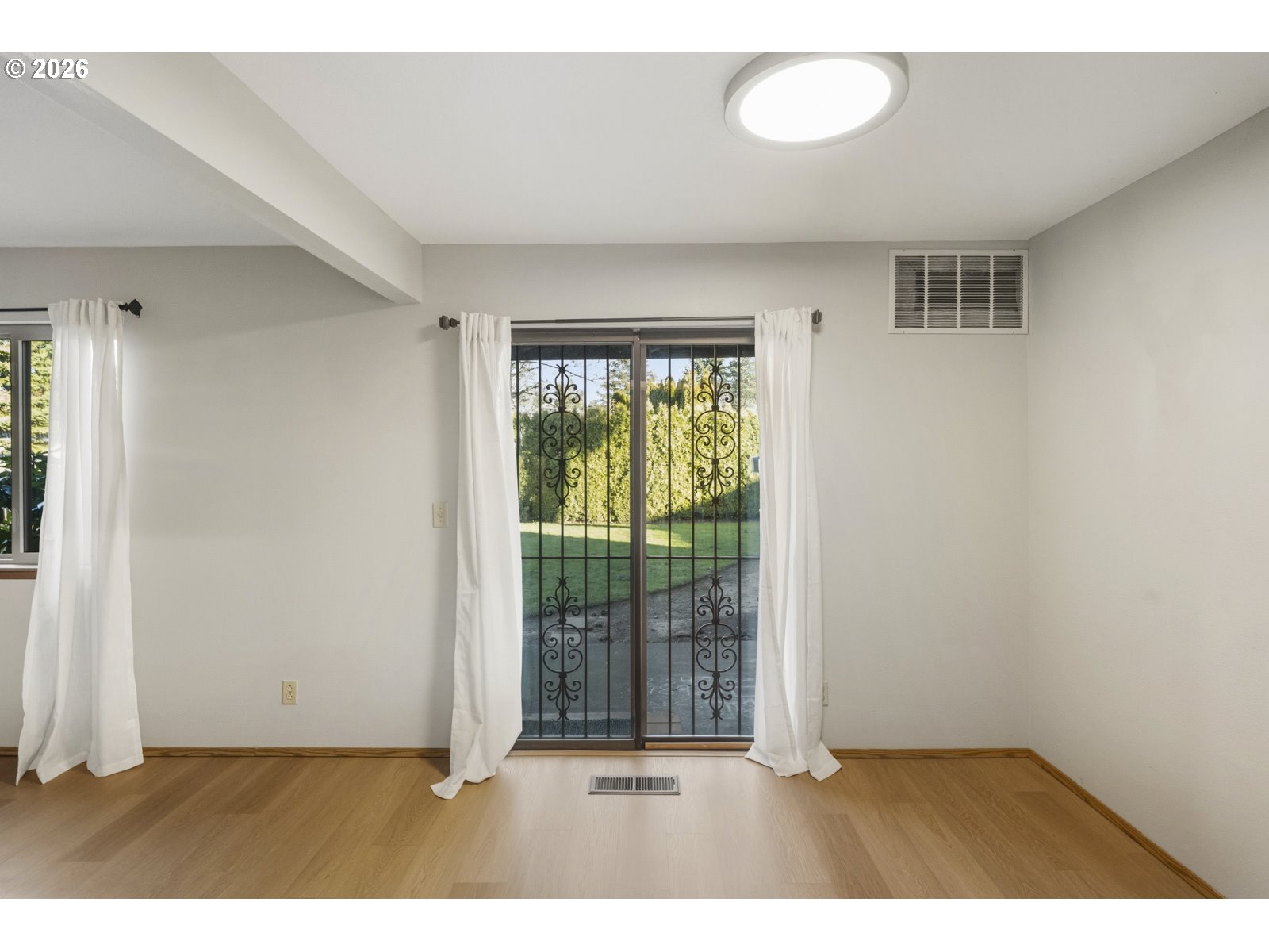 12516 Southeast Stark Street, Unit C Portland, OR 97233 - Photo 37 of 47 an empty room with windows