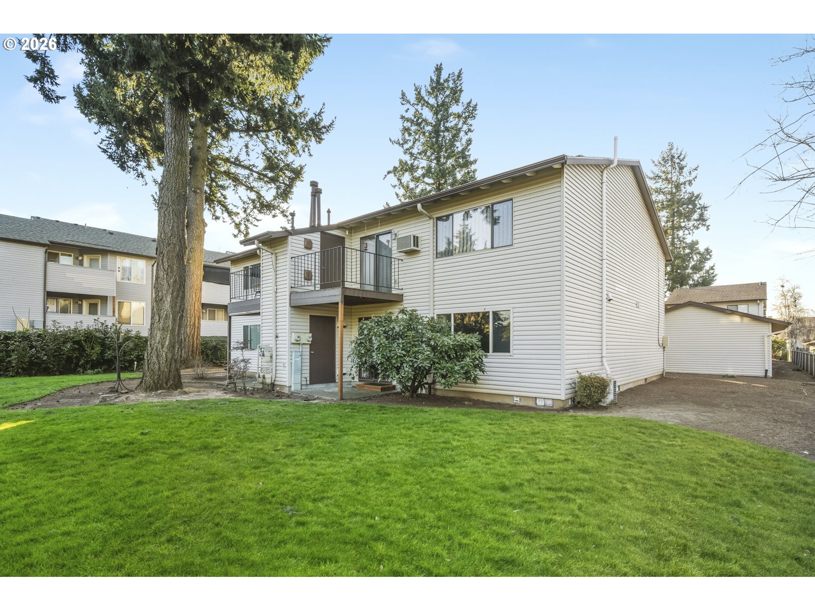 12516 Southeast Stark Street, Unit C Portland, OR 97233 - Photo 41 of 47 a front view of a house with a yard and garage