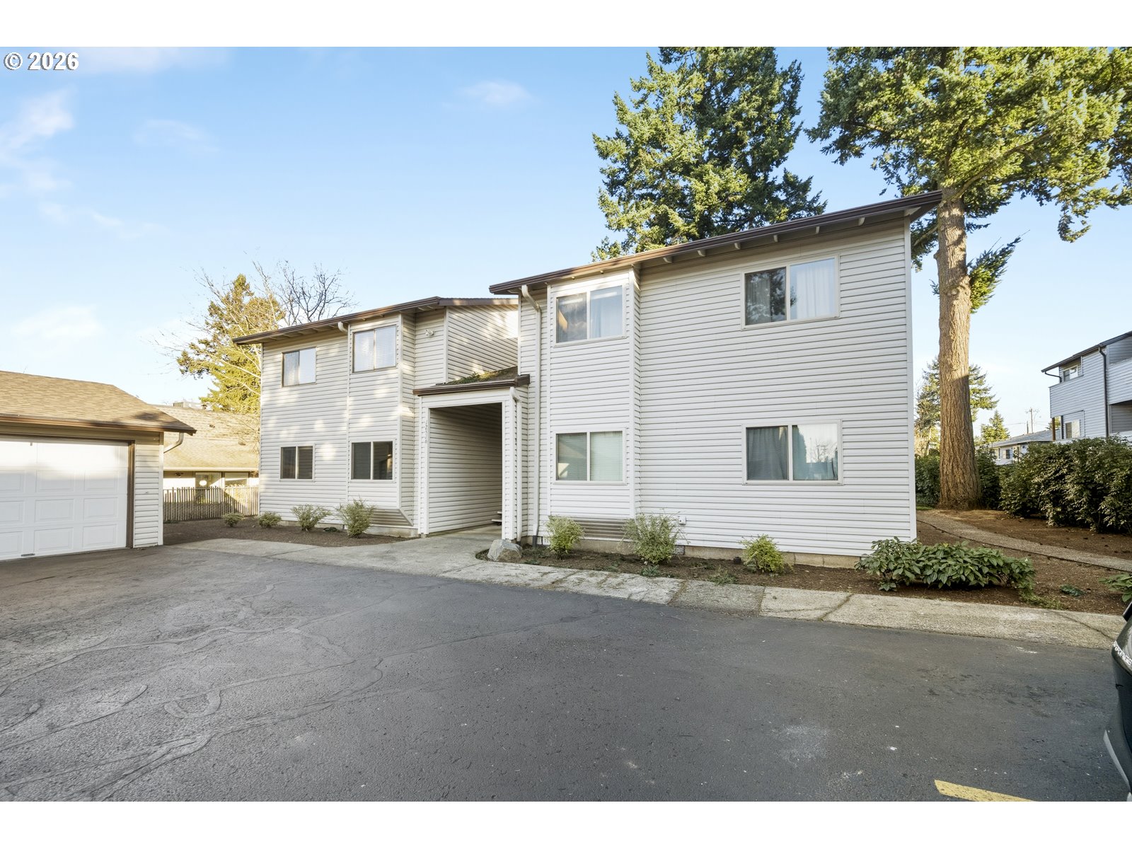 12516 Southeast Stark Street, Unit C Portland, OR 97233 - Photo 44 of 47 a view of a house with a outdoor space