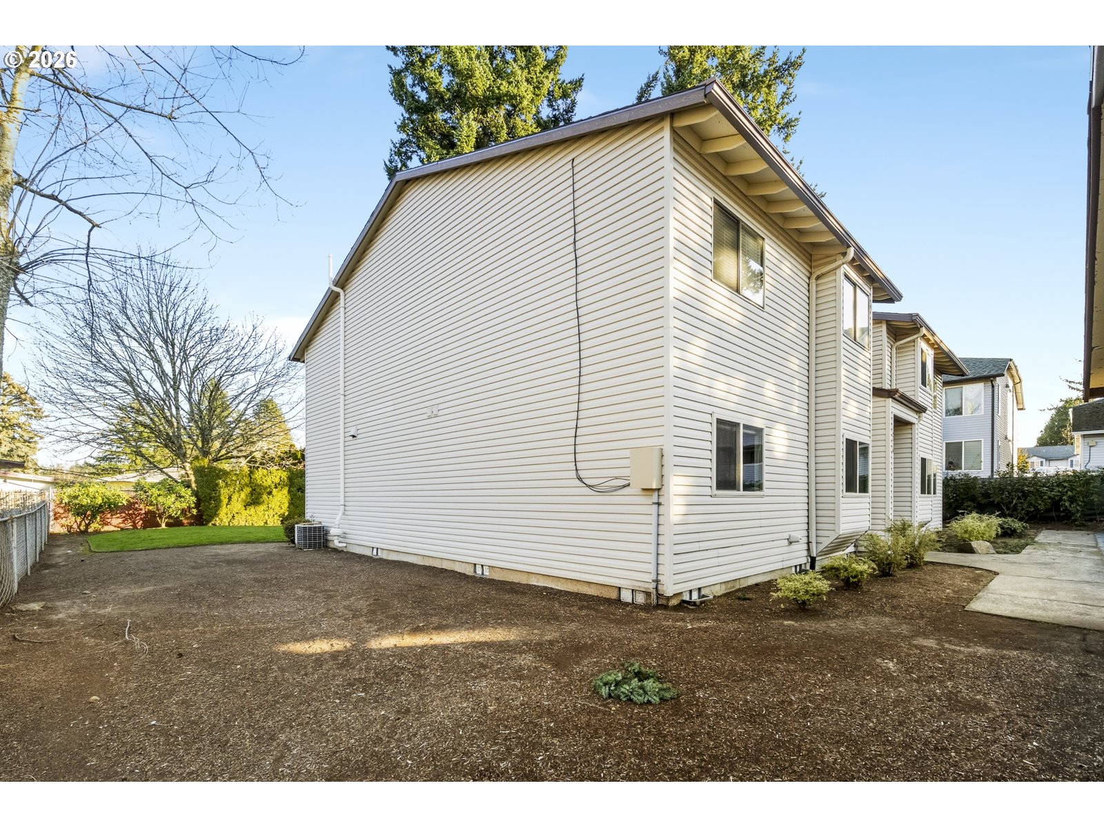 12516 Southeast Stark Street, Unit C Portland, OR 97233 - Photo 45 of 47 a view of a white house with a yard