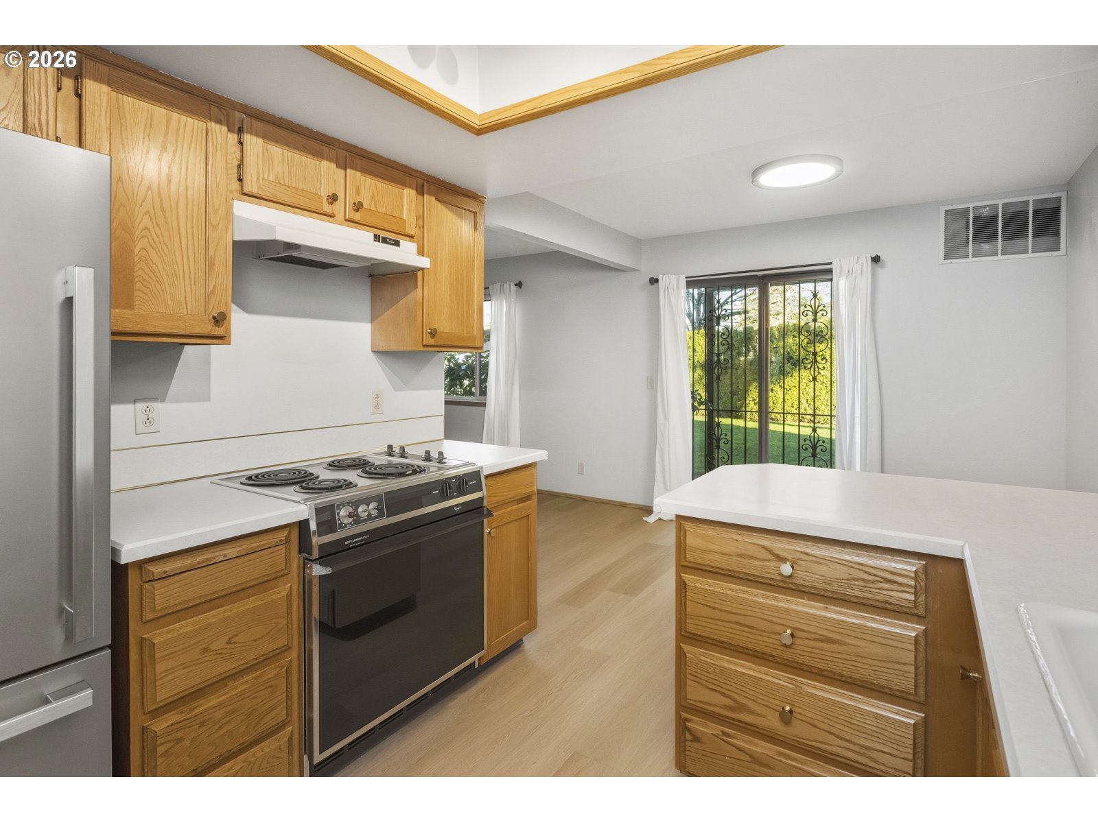12516 Southeast Stark Street, Unit C Portland, OR 97233 - Photo 8 of 47 a kitchen with a stove and a microwave
