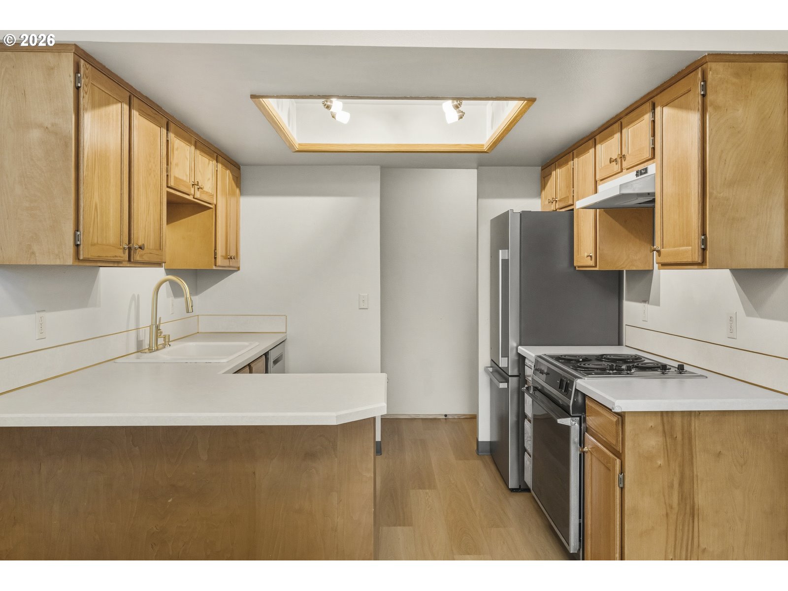 12516 Southeast Stark Street, Unit C Portland, OR 97233 - Photo 9 of 47 a kitchen with stainless steel appliances granite countertop a sink stove and refrigerator