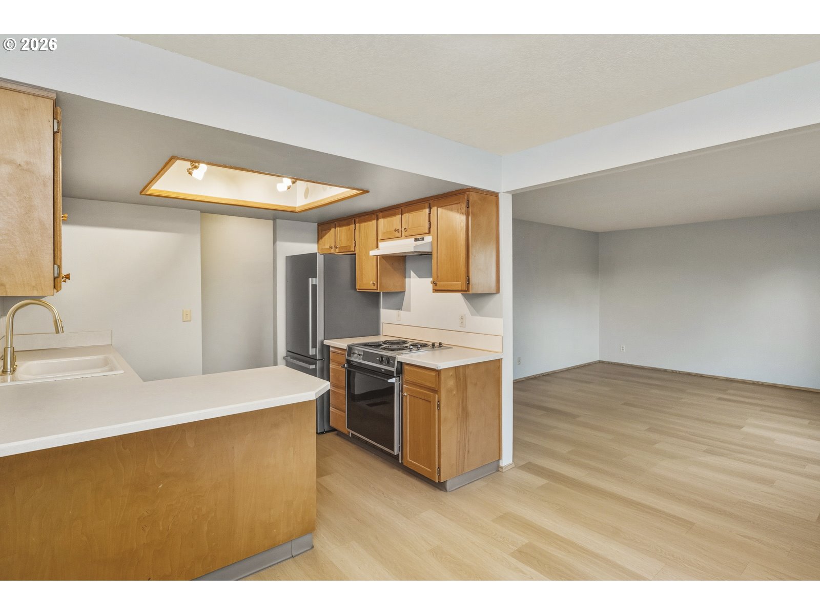 12516 Southeast Stark Street, Unit C Portland, OR 97233 - Photo 10 of 47 a kitchen with a sink appliances and cabinets
