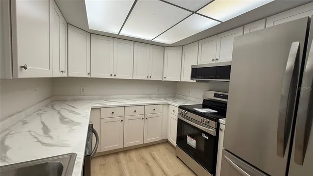 a kitchen with a sink stove and cabinets