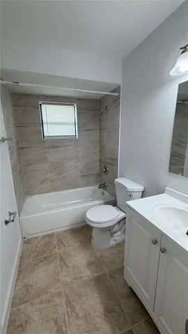 a bathroom with a toilet a sink and bathtub