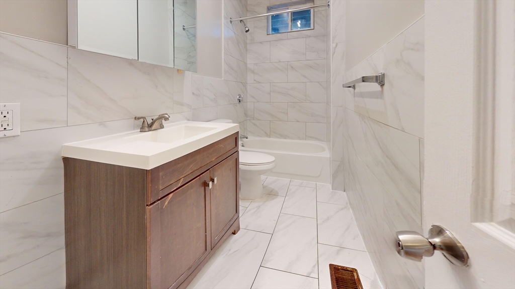 8 Wardman Road, Unit 1 Boston, MA 02119 - Photo 2 of 14 a bathroom with a sink a toilet and shower
