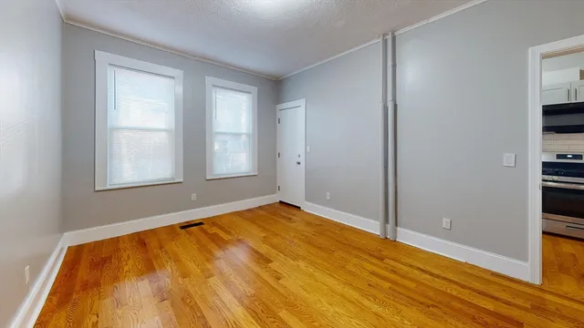 wooden floor in an empty room with a window