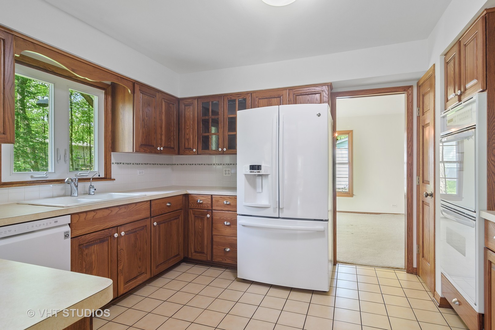 227 Tall Trees Lane Rolling Meadows, IL 60008 - Photo 3 of 15 a kitchen with a refrigerator sink and cabinets
