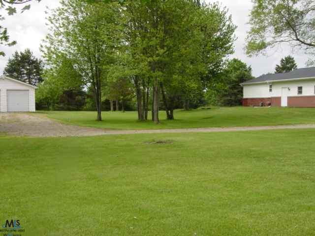 361 West Galbraith Line Road Melvin, MI 48454 - Photo 22 of 28 This is a view of the side yard between the house and the detached garage.