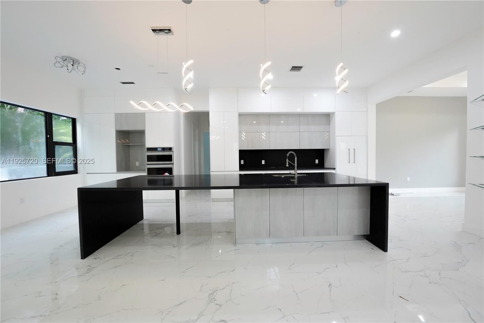 13083 Davie Oaks Drive Davie, FL 33325 - Photo 3 of 10 a large living room with stainless steel appliances kitchen island a large counter top and a couch