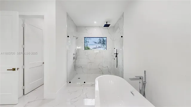 a bathroom with a tub shower and toilet