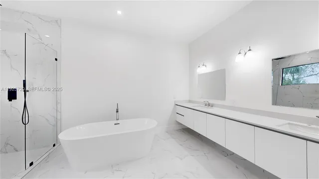 a bathroom with a tub sink and mirror