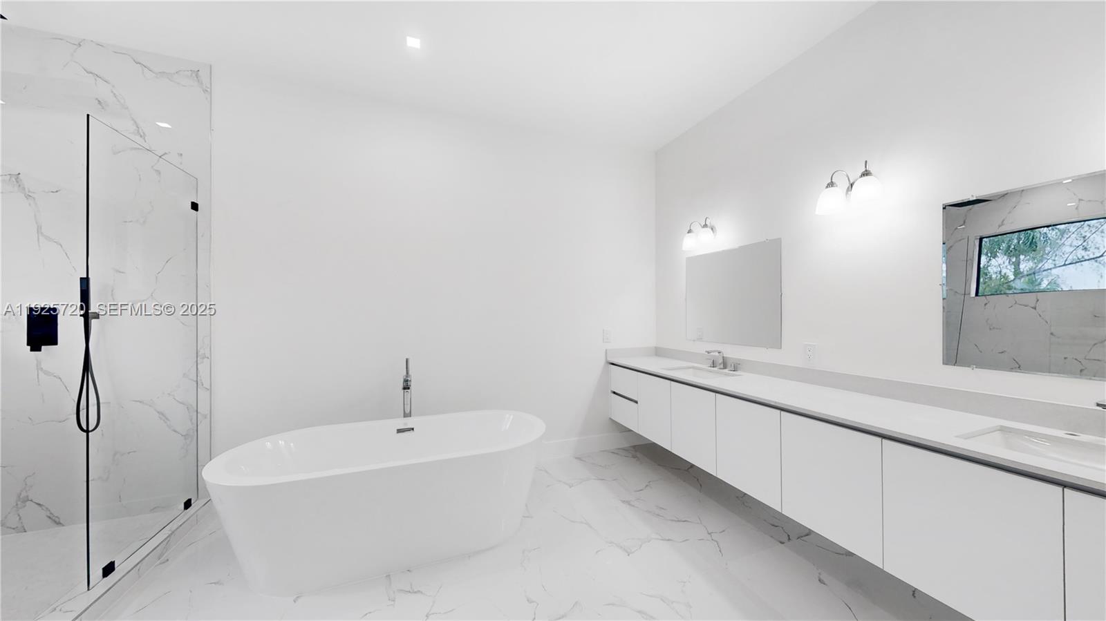 13083 Davie Oaks Drive Davie, FL 33325 - Photo 10 of 10 a bathroom with a tub sink and mirror