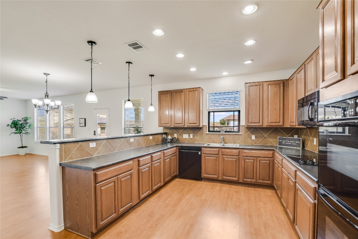 a large kitchen with stainless steel appliances granite countertop a sink and a stove