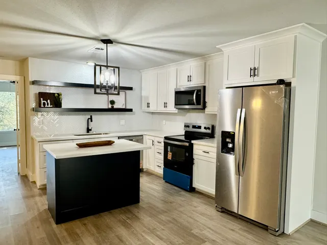 a spacious bedroom with a bed and a large window