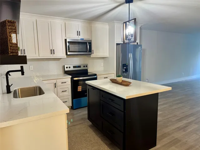 a spacious bedroom with a bed and a couch