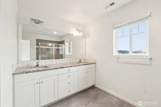 a bathroom with a granite countertop sink mirror and double
