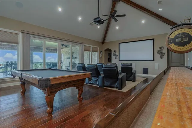 a room with furniture pool table flat screen tv and a large window