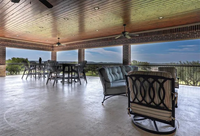 a kitchen with lots of wooden furniture cabinets and a table