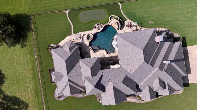 an aerial view of a house with outdoor space and lake view