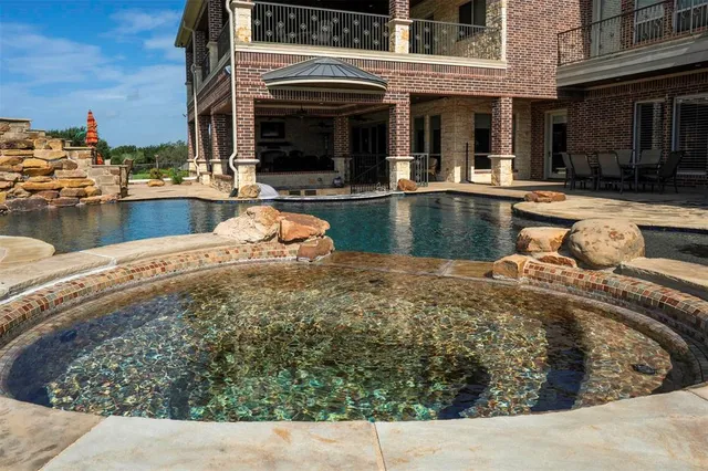 a view of a swimming pool with outdoor seating