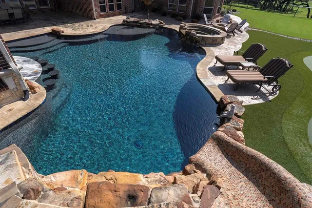 a view of a backyard with plants and a lake view