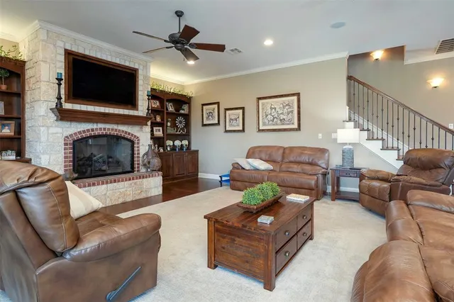 a living room with furniture a flat screen tv and a fireplace