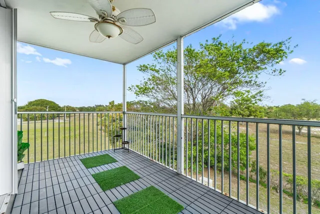a view of a balcony with a lake view and floor to ceiling window