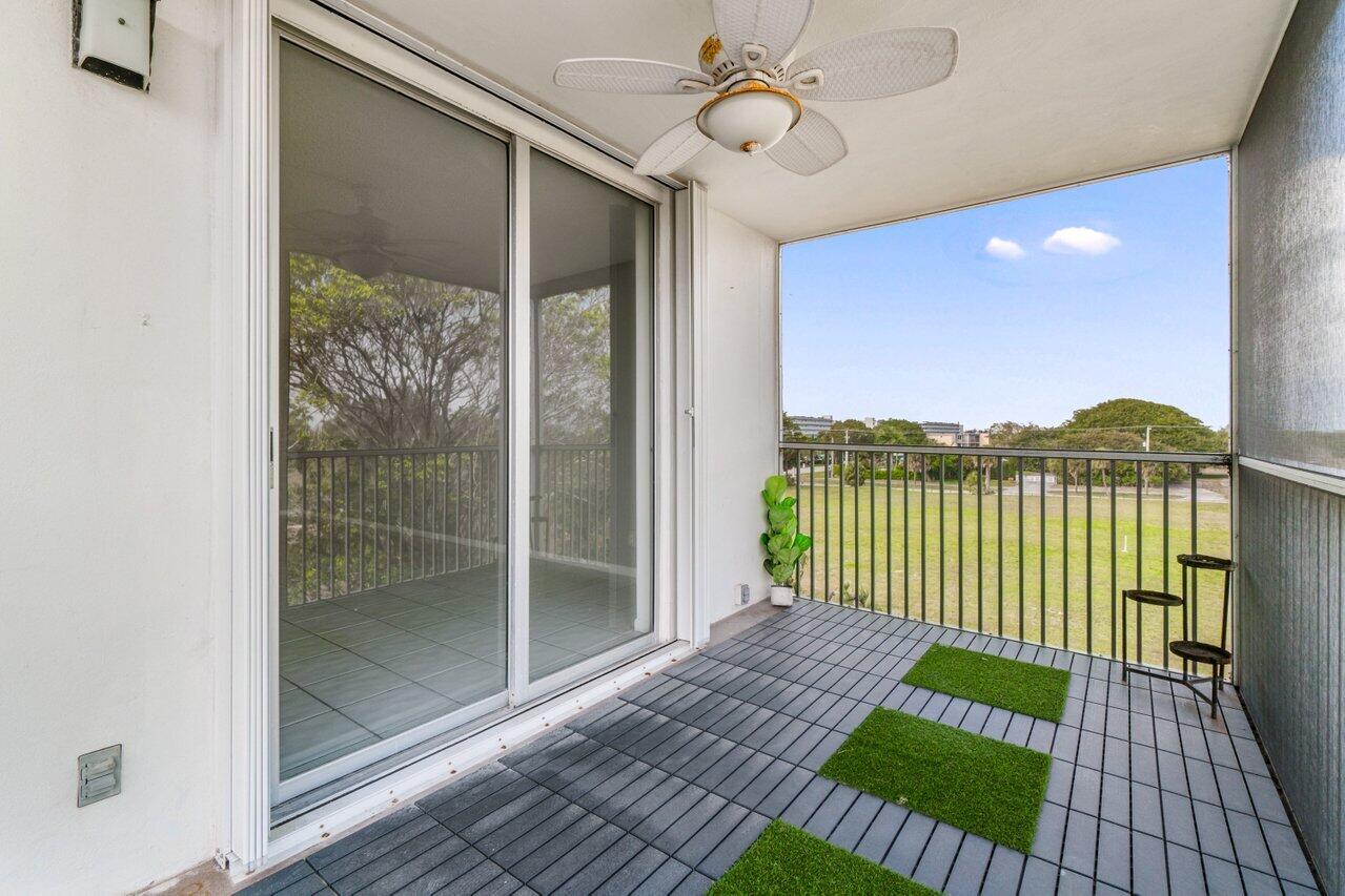5700 Northwest 2nd Avenue, Unit 401 Boca Raton, FL 33487 - Photo 26 of 30 a view of a balcony with a lake view and floor to ceiling window