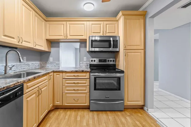 a kitchen with a stove a sink and a refrigerator