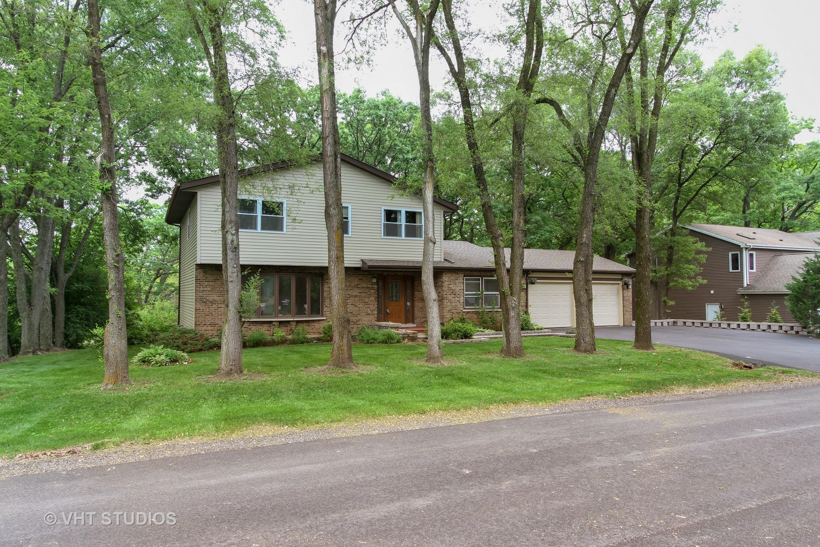 127 Hickory Road Oakwood Hills, IL 60013 - Photo 1 of 28 a view of a house with a yard and large trees