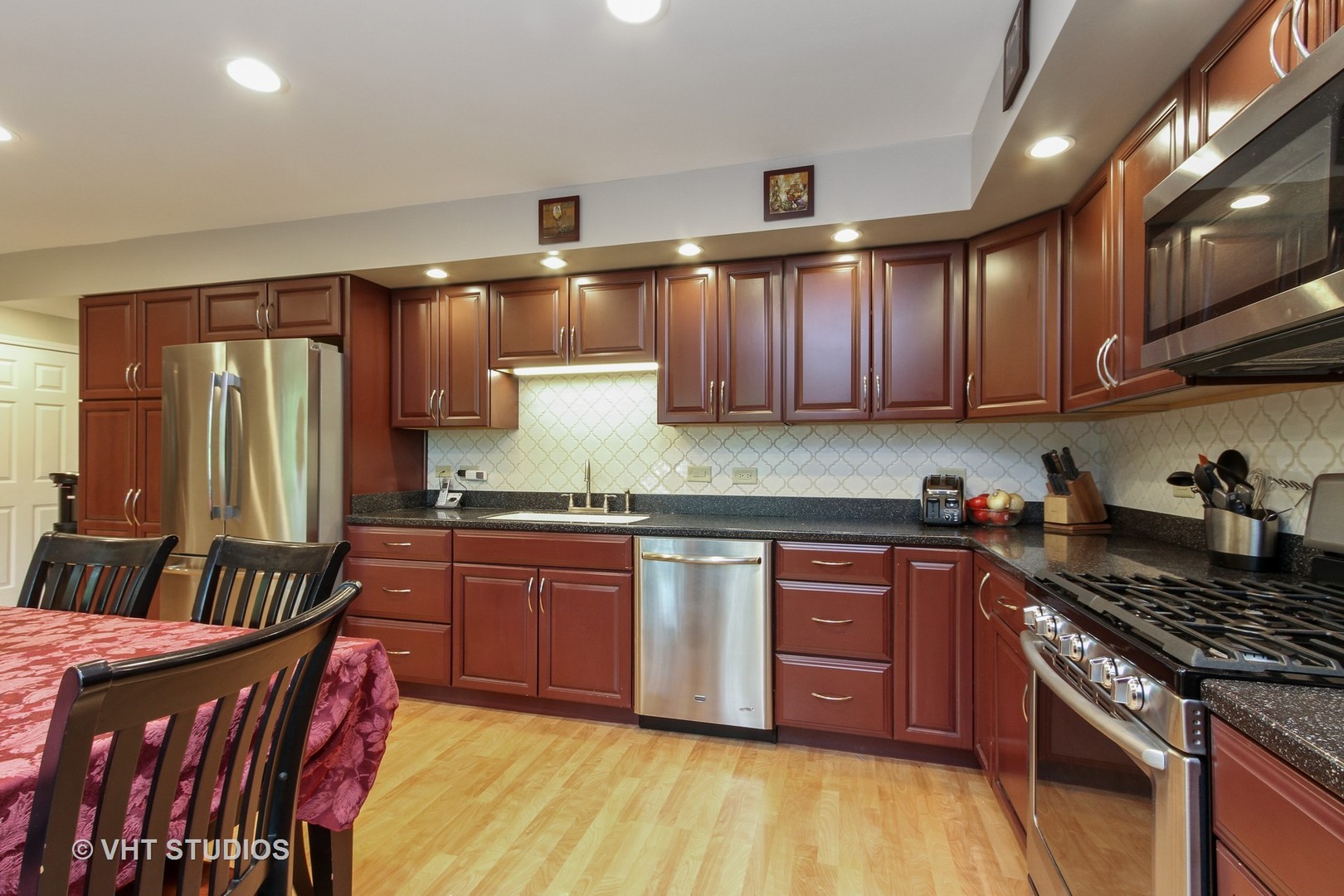 127 Hickory Road Oakwood Hills, IL 60013 - Photo 7 of 28 a kitchen with stainless steel appliances granite countertop a stove a sink dishwasher and a refrigerator with wooden cabinets