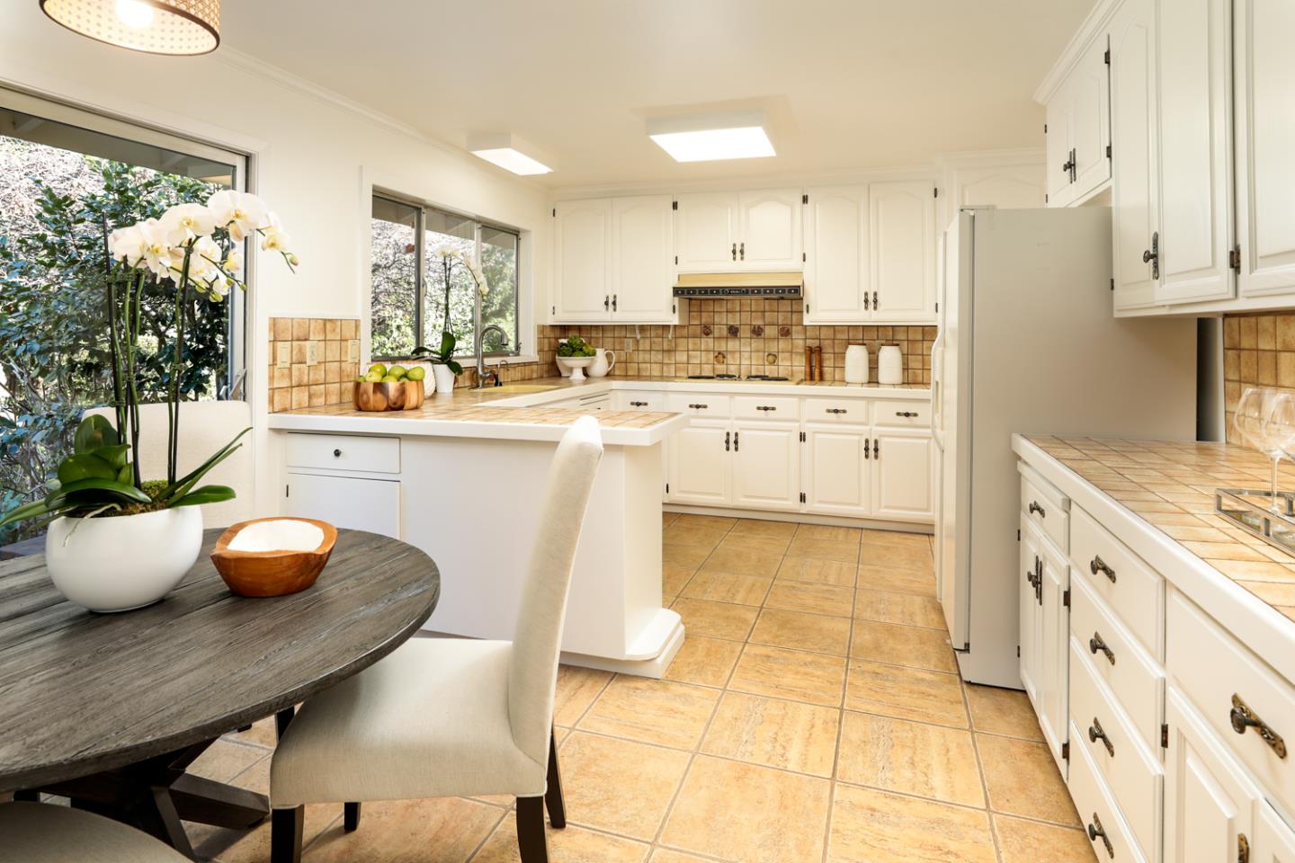 51 Fair Oaks Lane Atherton, CA 94027 - Photo 5 of 22 a kitchen with stainless steel appliances a white table chairs and a refrigerator