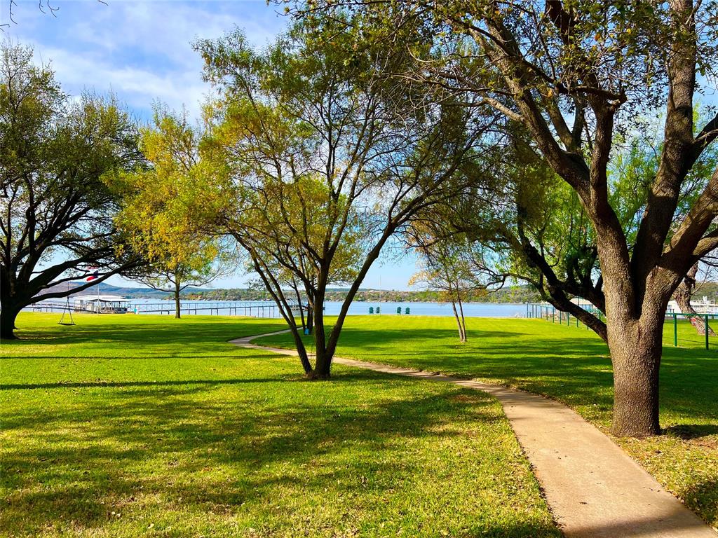 1957 Deer Trail Road Graford, TX 76449 - Photo 6 of 32 a view of a swimming pool with a garden and trees