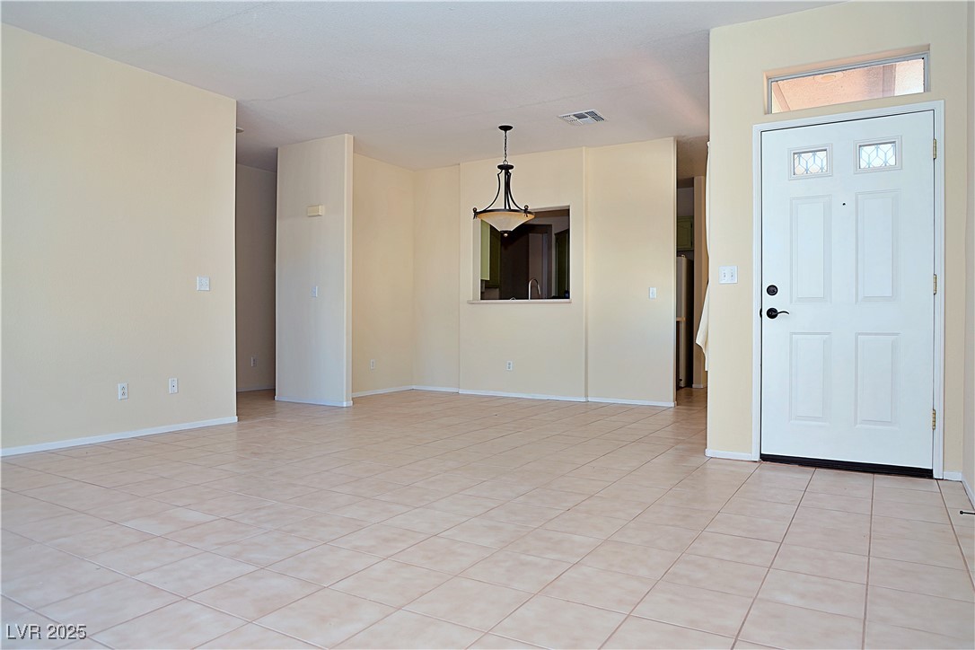 3349 Partridge Run Street Laughlin, NV 89029 - Photo 12 of 58 Foyer entrance featuring light tile patterned floors and baseboards