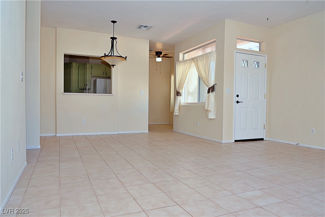 3349 Partridge Run Street Laughlin, NV 89029 - Photo 14 of 58 Unfurnished living room featuring light tile patterned floors and ceiling fan