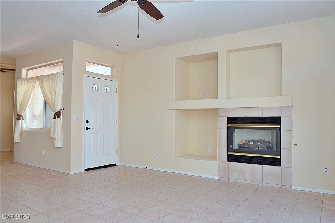 3349 Partridge Run Street Laughlin, NV 89029 - Photo 15 of 58 Foyer with a fireplace, a ceiling fan, and light tile patterned floors