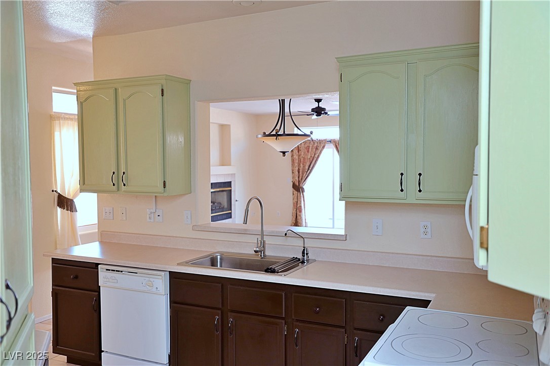 3349 Partridge Run Street Laughlin, NV 89029 - Photo 18 of 58 Kitchen featuring white appliances, light countertops, green cabinetry, and a ceiling fan