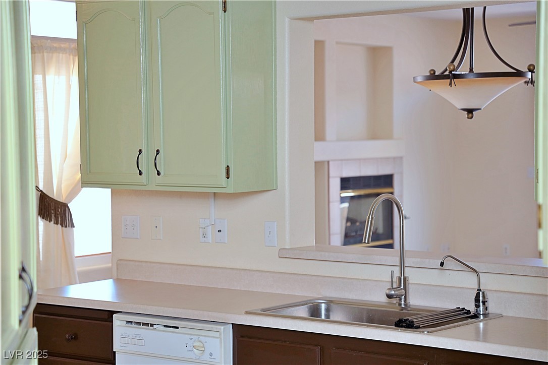 3349 Partridge Run Street Laughlin, NV 89029 - Photo 20 of 58 Kitchen featuring plenty of natural light, light countertops, dishwasher, and green cabinets