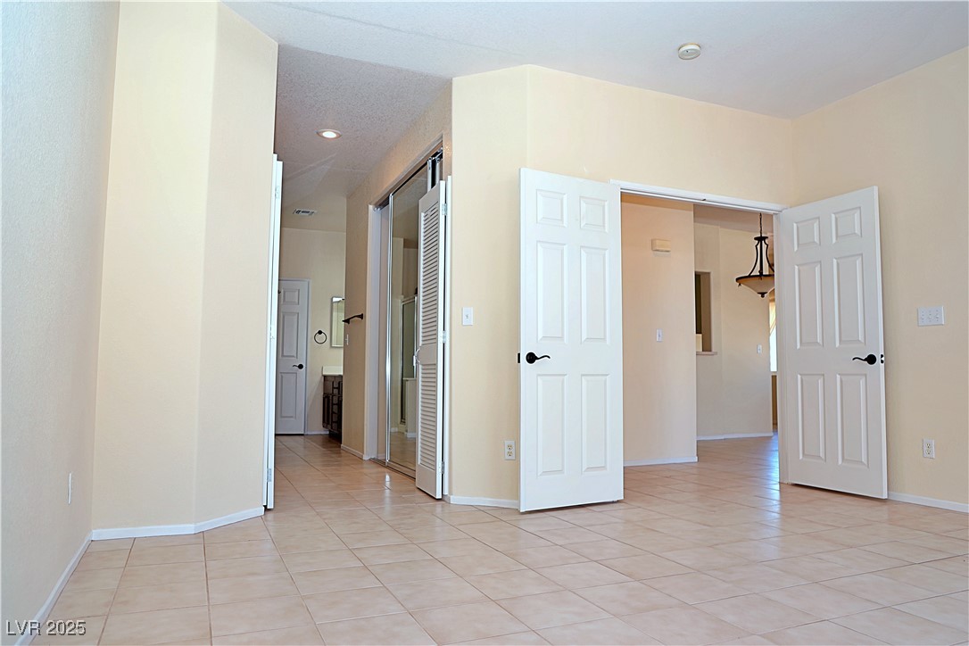 3349 Partridge Run Street Laughlin, NV 89029 - Photo 28 of 58 Empty room with light tile patterned floors and recessed lighting