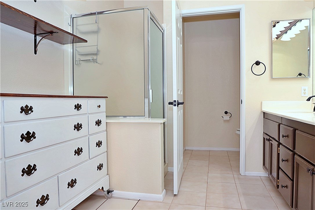 3349 Partridge Run Street Laughlin, NV 89029 - Photo 32 of 58 Full bathroom featuring light tile patterned floors, a shower stall, and vanity