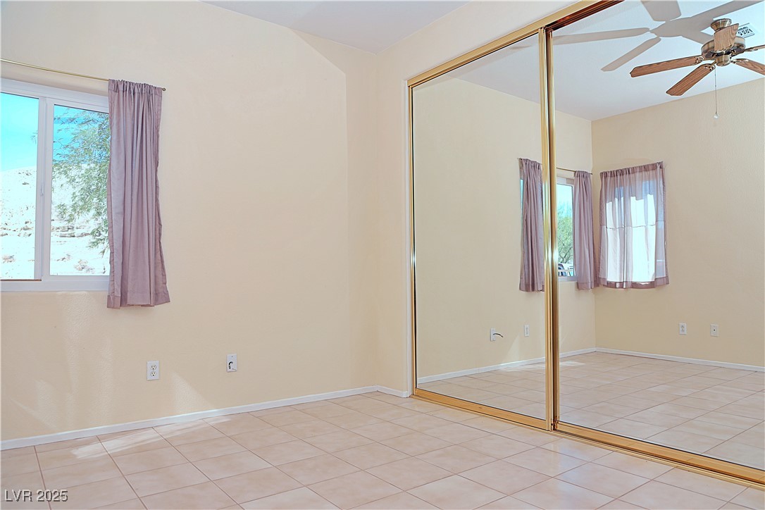 3349 Partridge Run Street Laughlin, NV 89029 - Photo 39 of 58 Unfurnished bedroom featuring light tile patterned floors, a closet, and ceiling fan